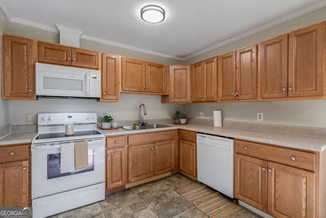 a kitchen with a sink stove and cabinets