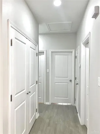 a view of a hallway with wooden shelves