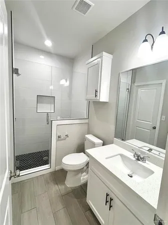 a bathroom with a sink toilet and shower