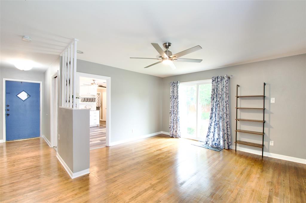 1307 North 65th Street Waco, TX 76710 - Photo 4 of 35 an empty room with wooden floor and window