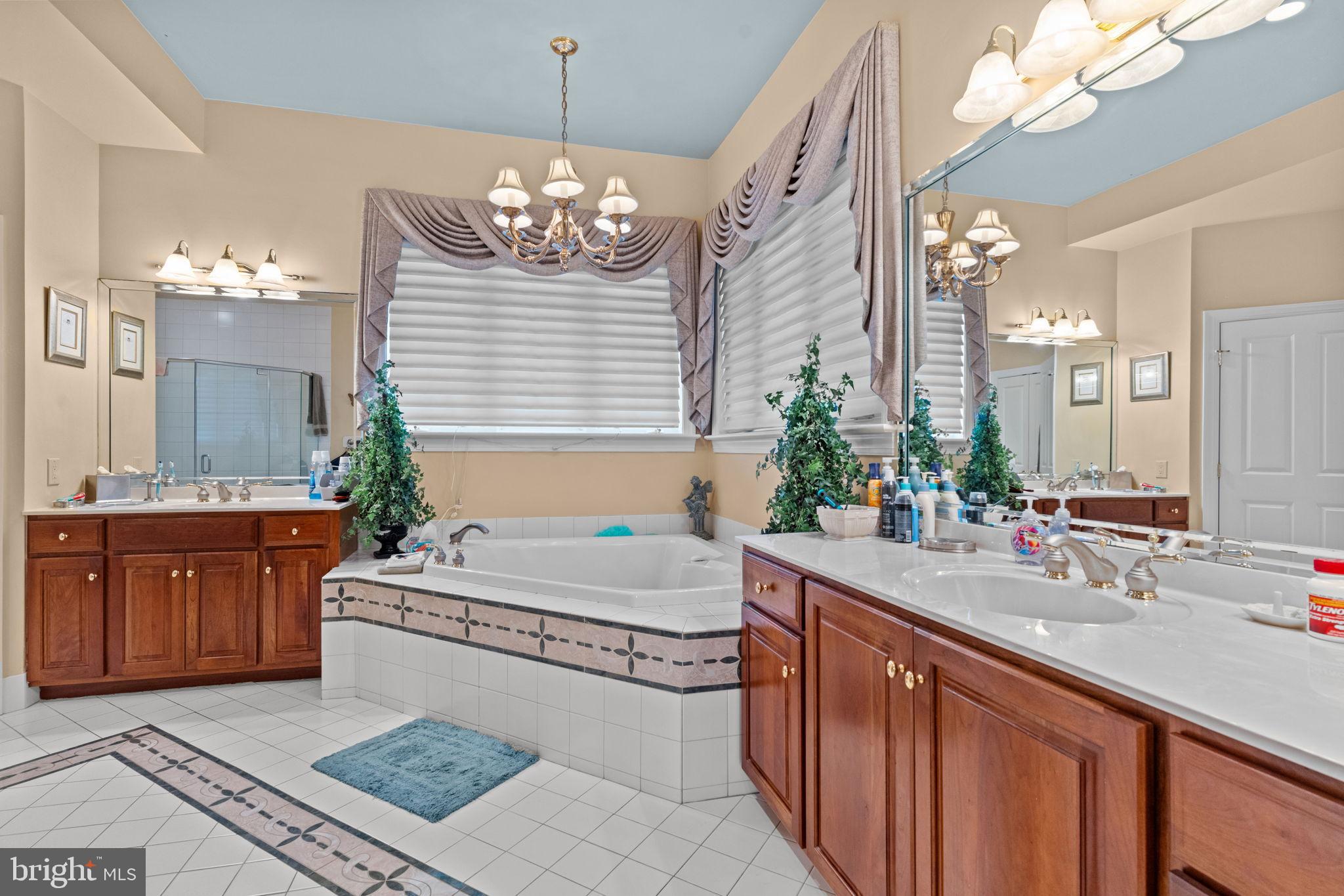 2175 Jefferson Lane Huntingdon Valley, PA 19006 - Photo 32 of 95 a spacious bathroom with a granite countertop sink a large mirror and a bathtub