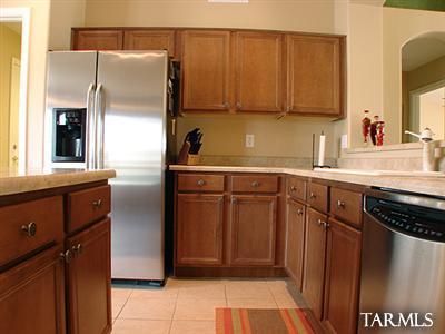 62195 East Northwood Road Tucson, AZ 85739 - Photo 13 of 25 a kitchen with a sink a refrigerator and cabinets