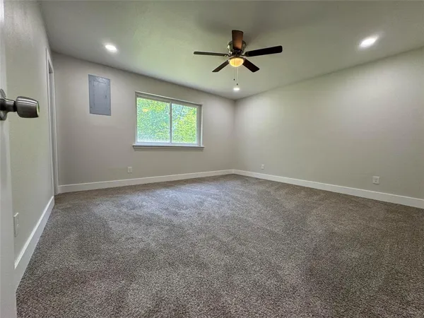 an empty room with closet and windows