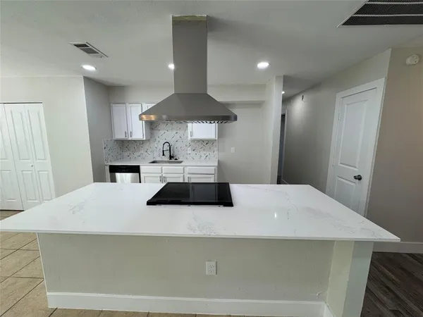 a stove top oven sitting inside of a kitchen