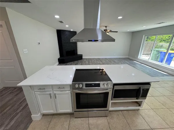 a kitchen with a sink stove and cabinets