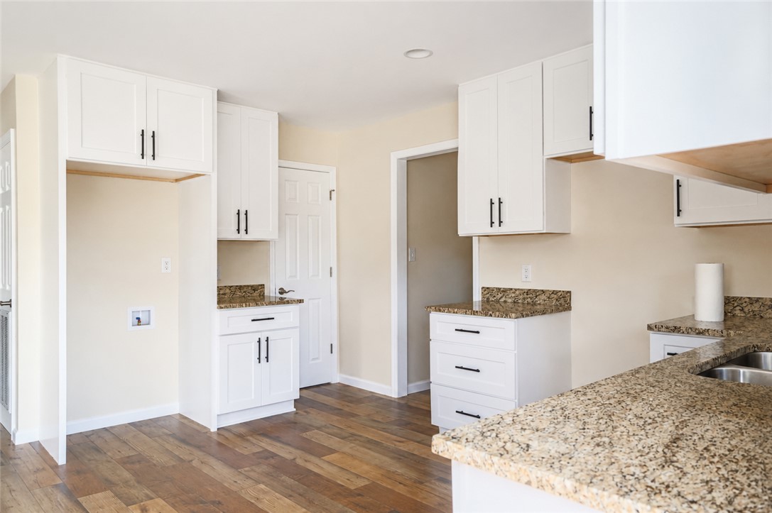 605 Hampton Street Iva, SC 29655 - Photo 6 of 16 Bright, inviting kitchen space featuring rich hardwood flooring and sleek, modern cabinetry.