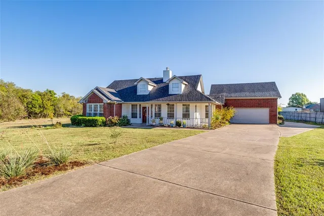 a front view of house with yard outdoor seating and barbeque oven