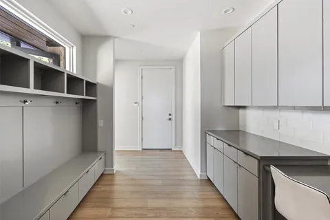 a hallway with a sink and cabinets