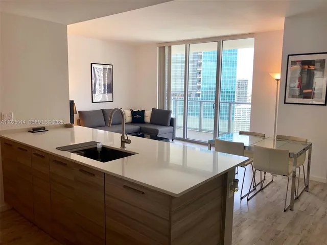 a living room with furniture and large windows
