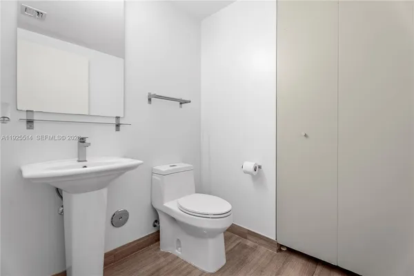 a bathroom with a sink toilet and a mirror