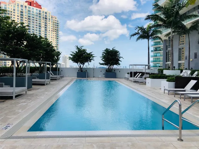 a view of a patio with table and chairs with wooden floor and fence
