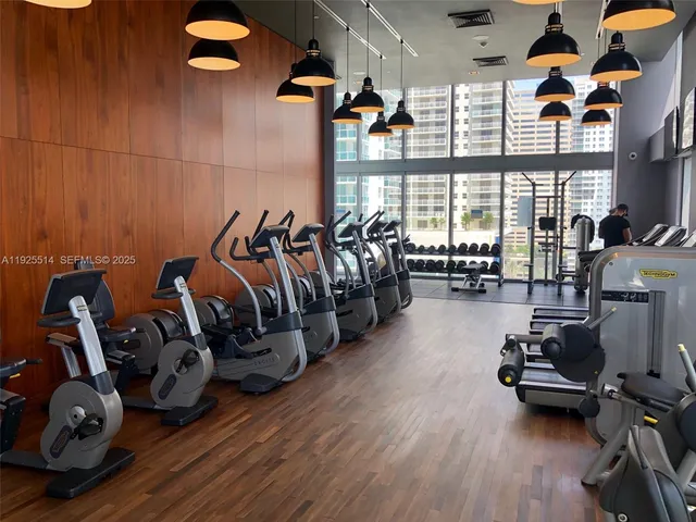 a kitchen with stainless steel appliances granite countertop a stove and a wooden floors