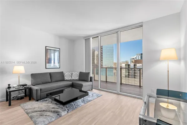 a living room with furniture and a lamp