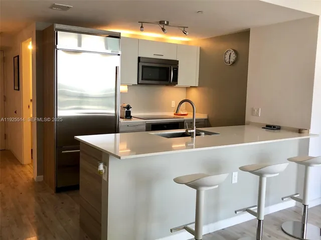 a kitchen with a sink and a microwave