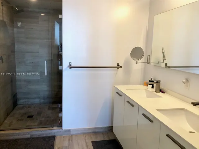 a bathroom with a shower and a sink