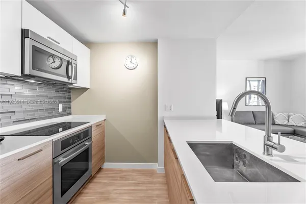 a kitchen with a sink and a stove top oven