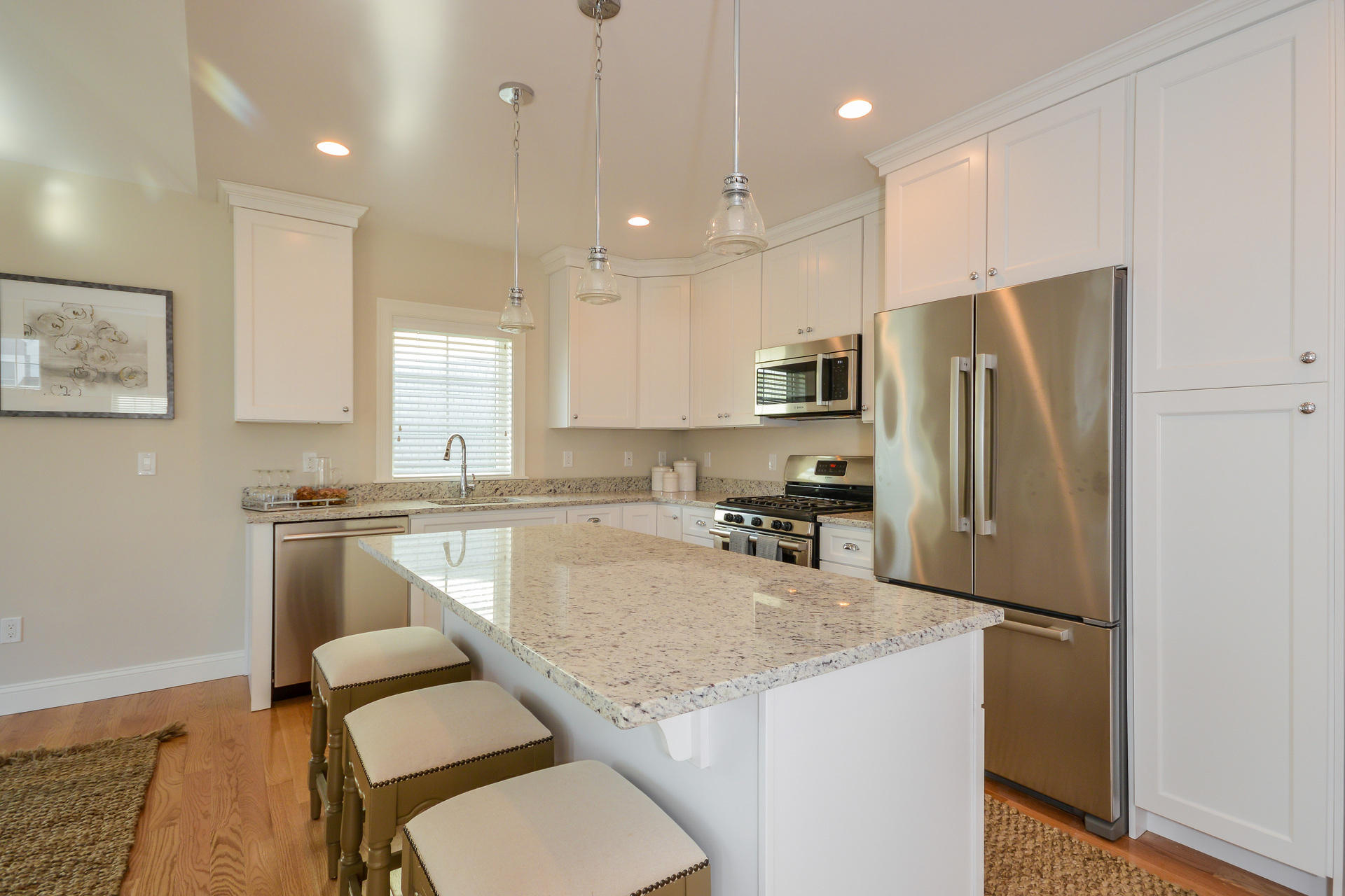8 Azalea Lane Mashpee, MA 02649 - Photo 9 of 30 a kitchen with a refrigerator a sink a stove a microwave and wooden floor