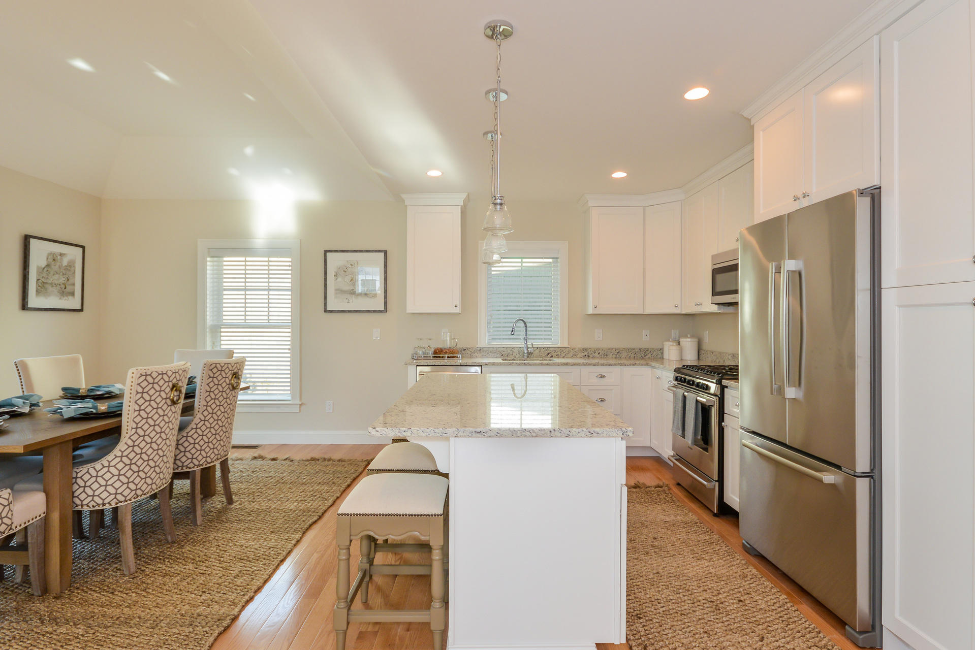 8 Azalea Lane Mashpee, MA 02649 - Photo 10 of 30 a kitchen with refrigerator a sink and chairs
