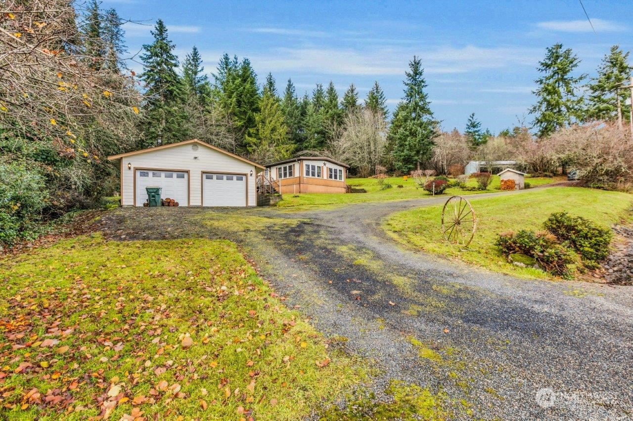 487 Tennessee Road Winlock, WA 98596 - Photo 1 of 33 a view of a house with a big yard and large trees