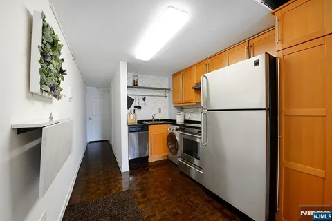 a kitchen with a refrigerator a stove top oven and a refrigerator