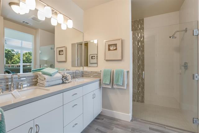 889 North San Antonio Road, Unit 2000 Los Altos, CA 94022 - Photo 11 of 14 a bathroom with a granite countertop shower sink and mirror
