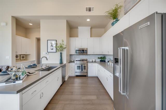 889 North San Antonio Road, Unit 2000 Los Altos, CA 94022 - Photo 8 of 14 a large kitchen with stainless steel appliances lots of counter space and a sink