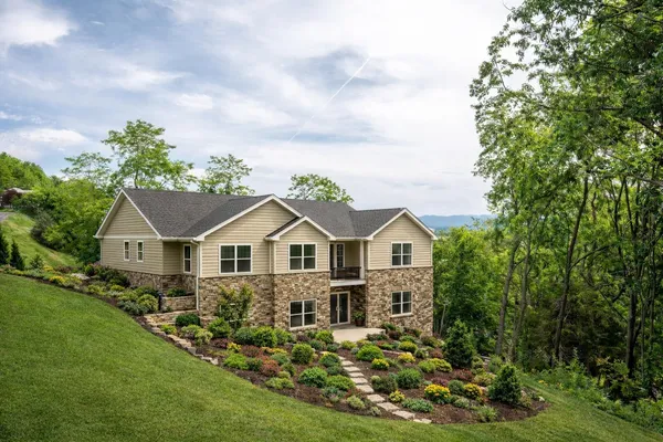 a front view of a house with a garden