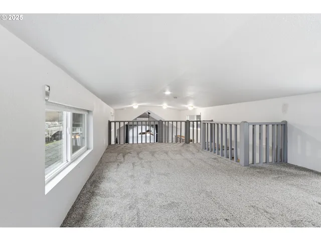 a view of an empty room with cabinet and entryway