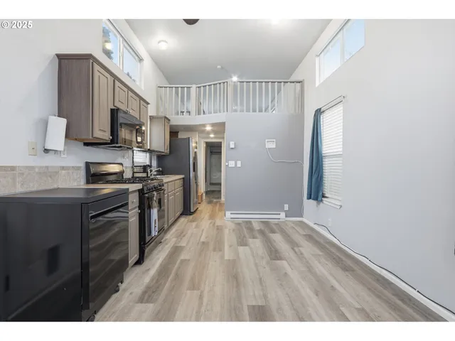 a kitchen with stainless steel appliances a refrigerator and a sink