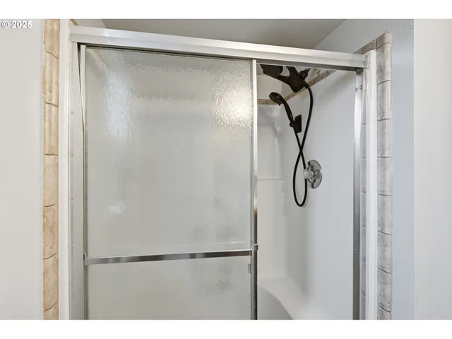 a bathroom with a glass shower door