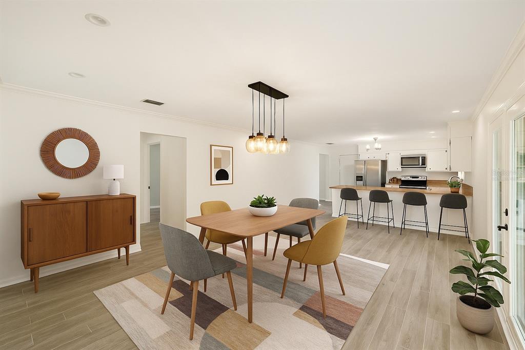 4805 Southwest 19th Street Gainesville, FL 32608 - Photo 16 of 43 a dining room with furniture and a chandelier