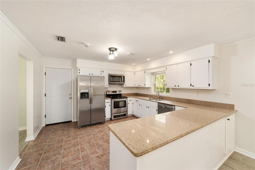 4805 Southwest 19th Street Gainesville, FL 32608 - Photo 21 of 43 a kitchen with refrigerator and cabinets