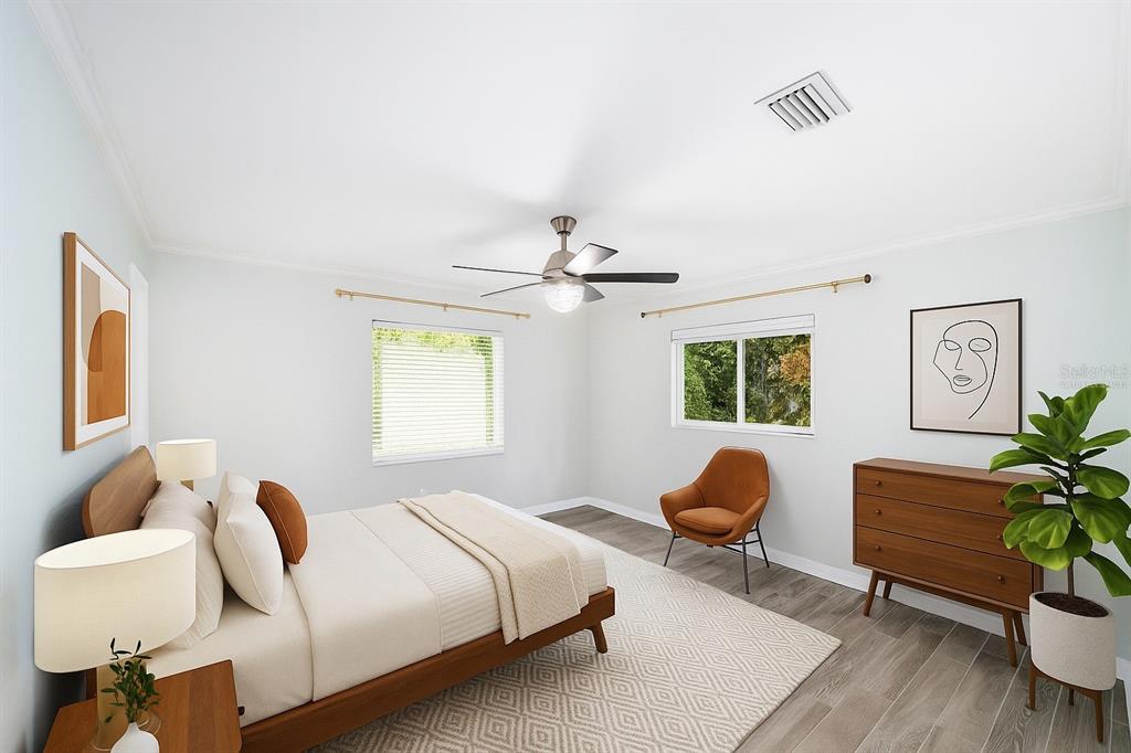 4805 Southwest 19th Street Gainesville, FL 32608 - Photo 23 of 43 a bedroom with a bed and a potted plant