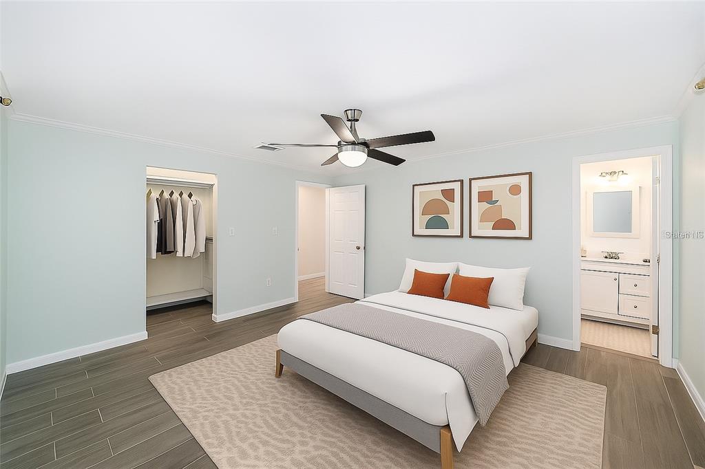 4805 Southwest 19th Street Gainesville, FL 32608 - Photo 24 of 43 a bedroom with a large bed and a chandelier