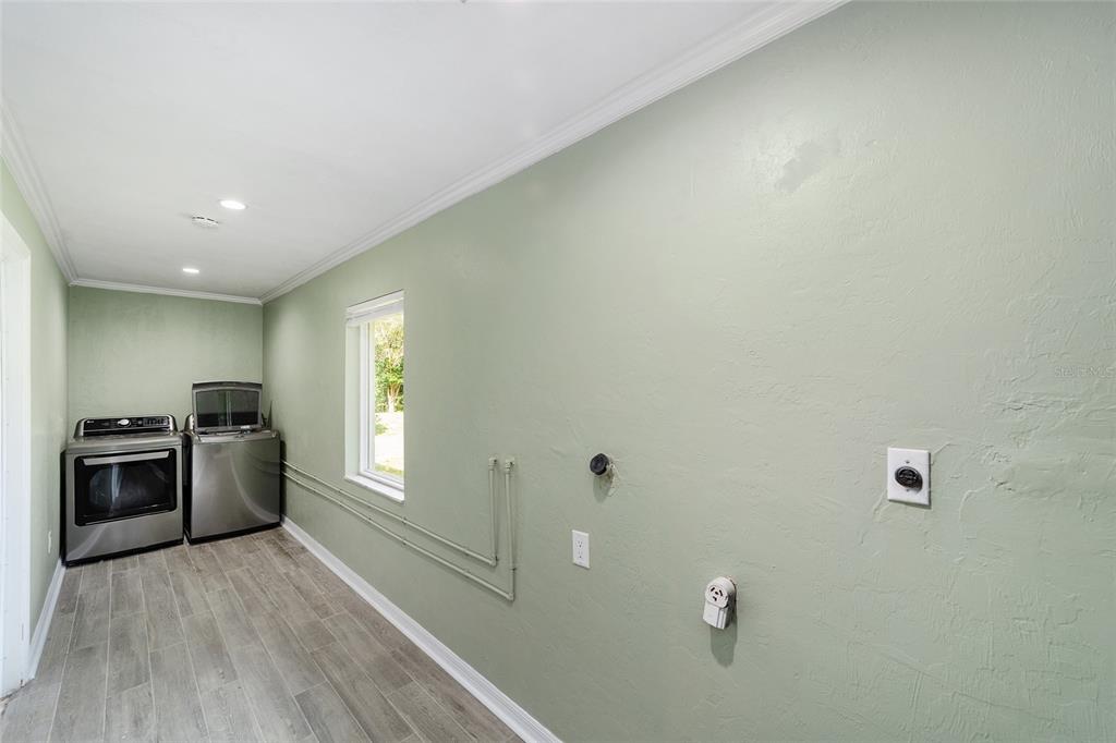 4805 Southwest 19th Street Gainesville, FL 32608 - Photo 30 of 43 a kitchen with a refrigerator and a stove top oven