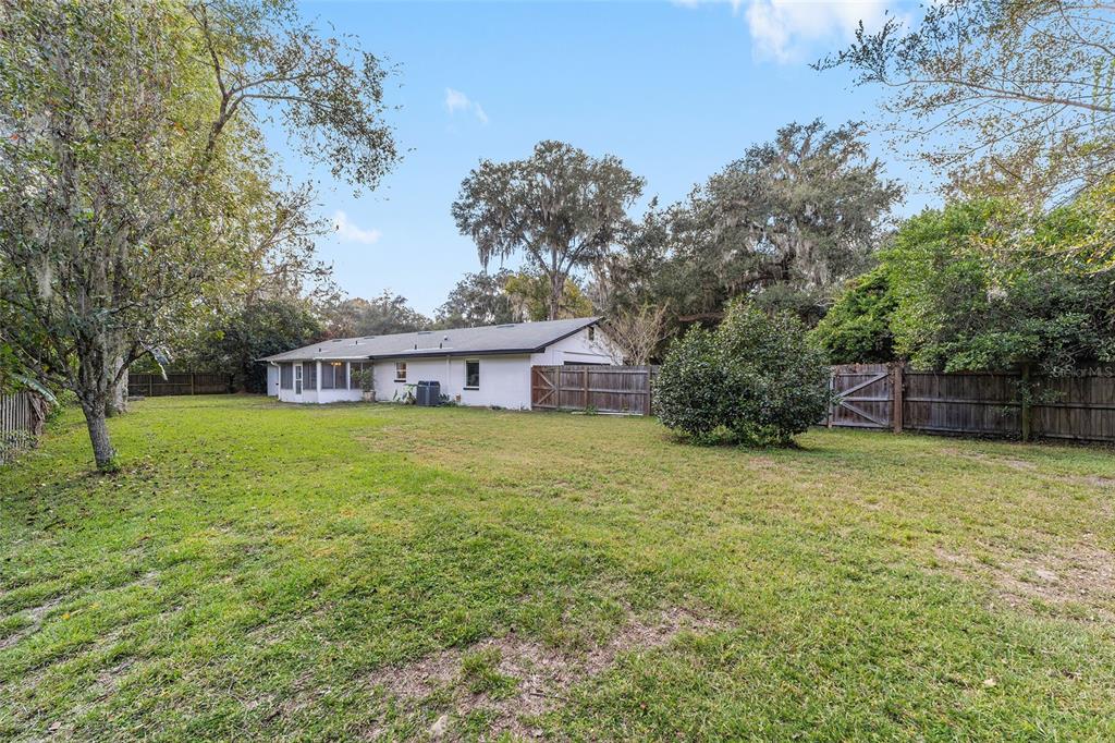 4805 Southwest 19th Street Gainesville, FL 32608 - Photo 38 of 43 a front view of house with yard and trees in the background