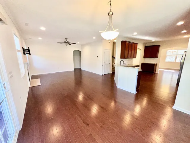 a view of a kitchen with furniture and wooden floor