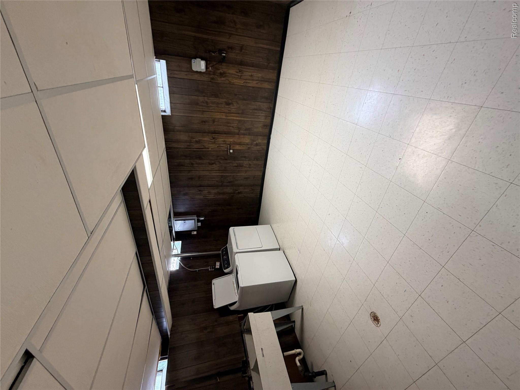 65 Hampton Road Grosse Pointe, MI 48236 - Photo 16 of 21 Below grade area featuring wood walls, light floors, and washer and clothes dryer