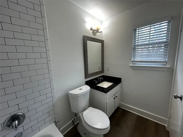 a white toilet sitting next to a bathroom sink