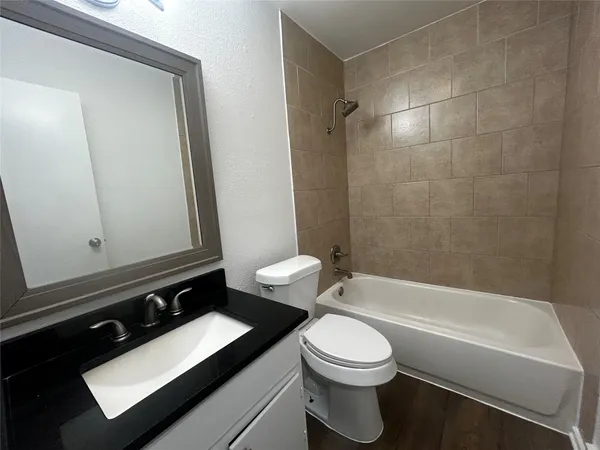 a bathroom with a toilet a sink and bathtub