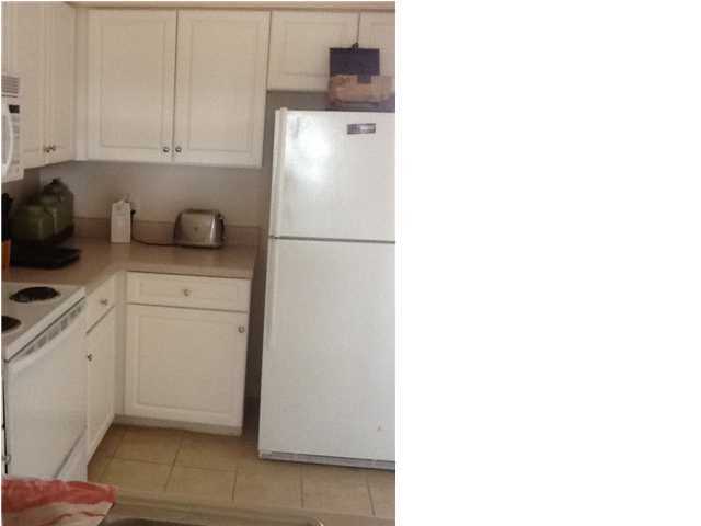 4270 Calinda Lane, Unit 357 Niceville, FL 32578 - Photo 4 of 17 a kitchen with a refrigerator and cabinets