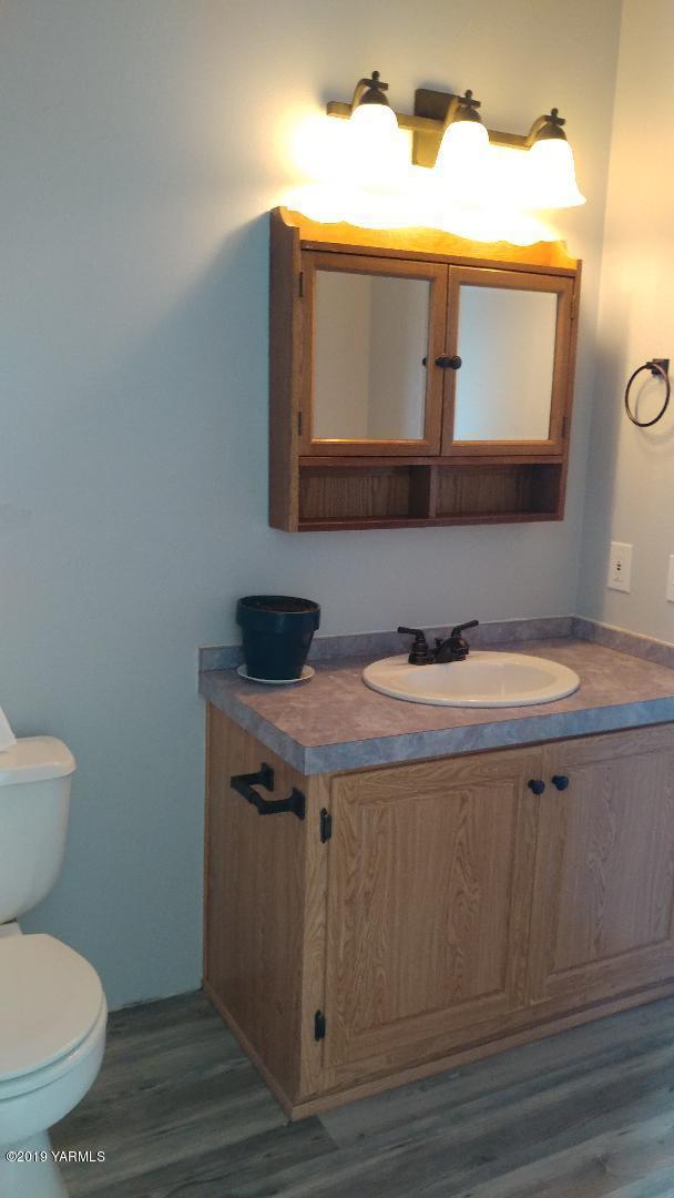 910 North Tieton Road Tieton, WA 98947 - Photo 14 of 20 a bathroom with a sink and a toilet