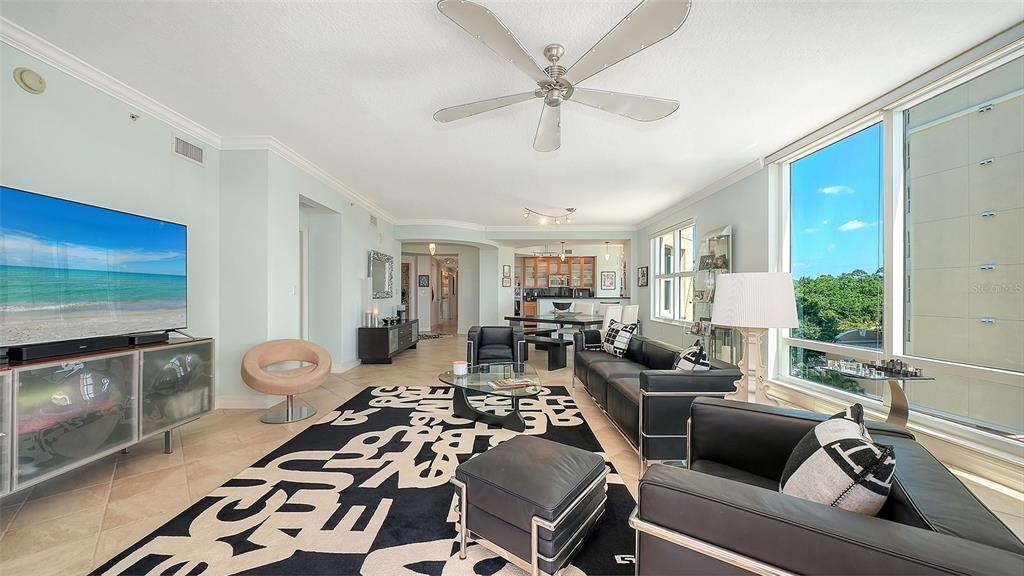 409 North Point Road, Unit 401 Osprey, FL 34229 - Photo 15 of 90 a living room with furniture a flat screen tv and a fireplace
