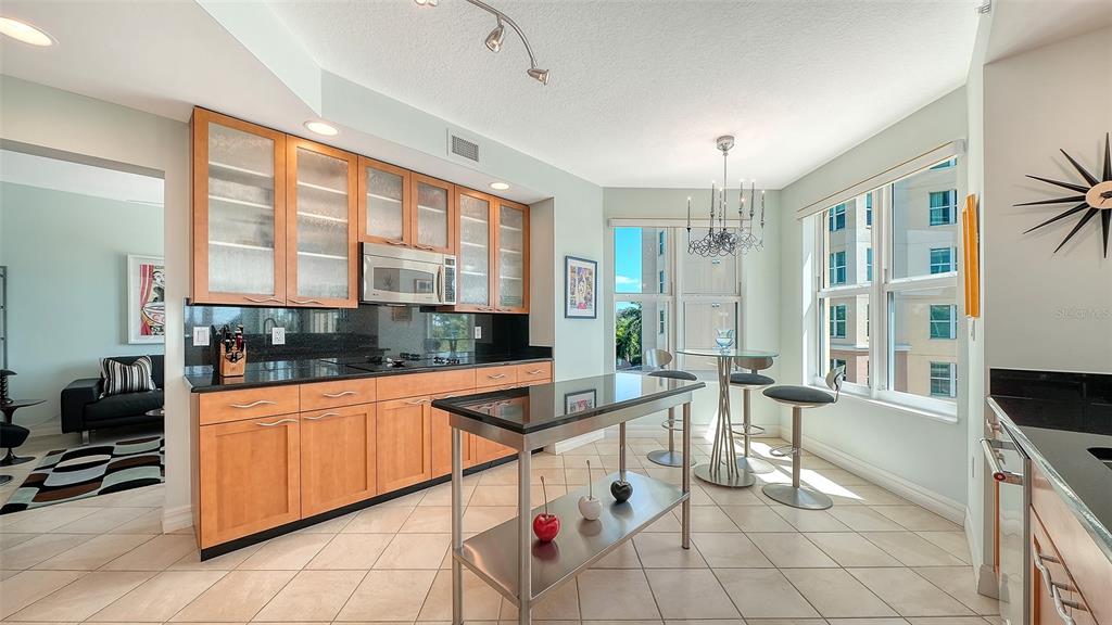 409 North Point Road, Unit 401 Osprey, FL 34229 - Photo 20 of 90 a kitchen with stainless steel appliances granite countertop sink and cabinets