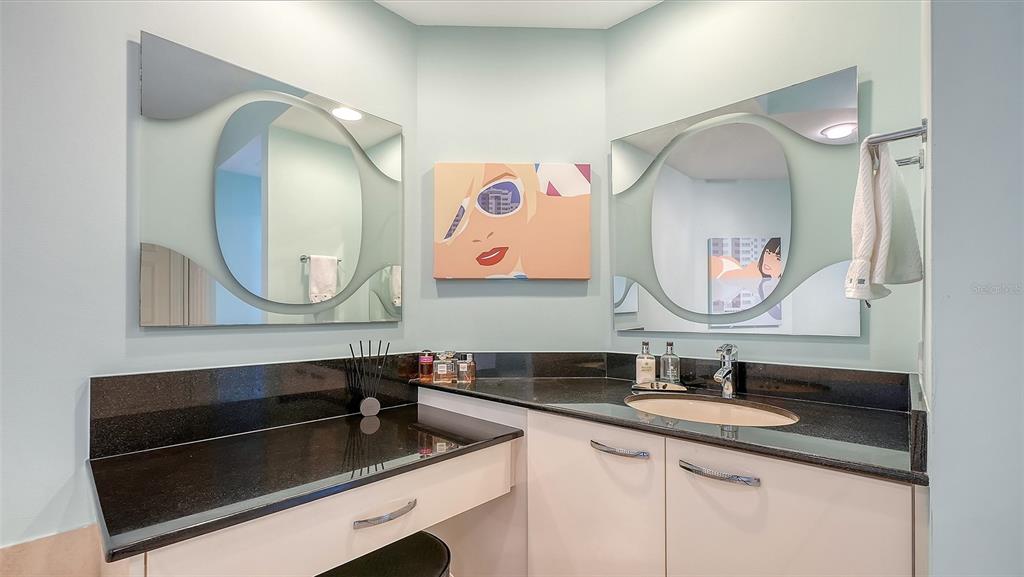 409 North Point Road, Unit 401 Osprey, FL 34229 - Photo 33 of 90 a bathroom with a sink and a mirror
