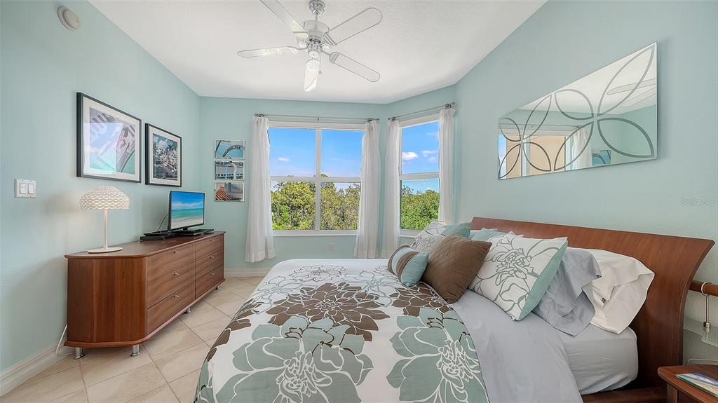 409 North Point Road, Unit 401 Osprey, FL 34229 - Photo 40 of 90 a bedroom with a bed and a chandelier