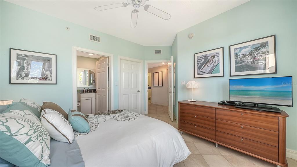 409 North Point Road, Unit 401 Osprey, FL 34229 - Photo 41 of 90 a bedroom with a bed and a flat screen tv