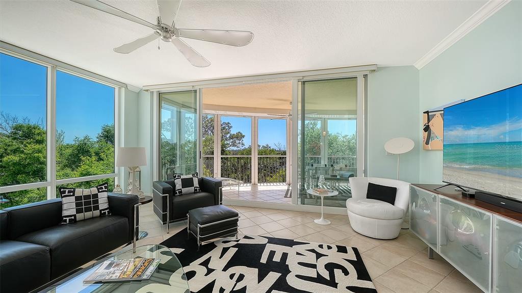 409 North Point Road, Unit 401 Osprey, FL 34229 - Photo 9 of 90 a living room with furniture and a large window