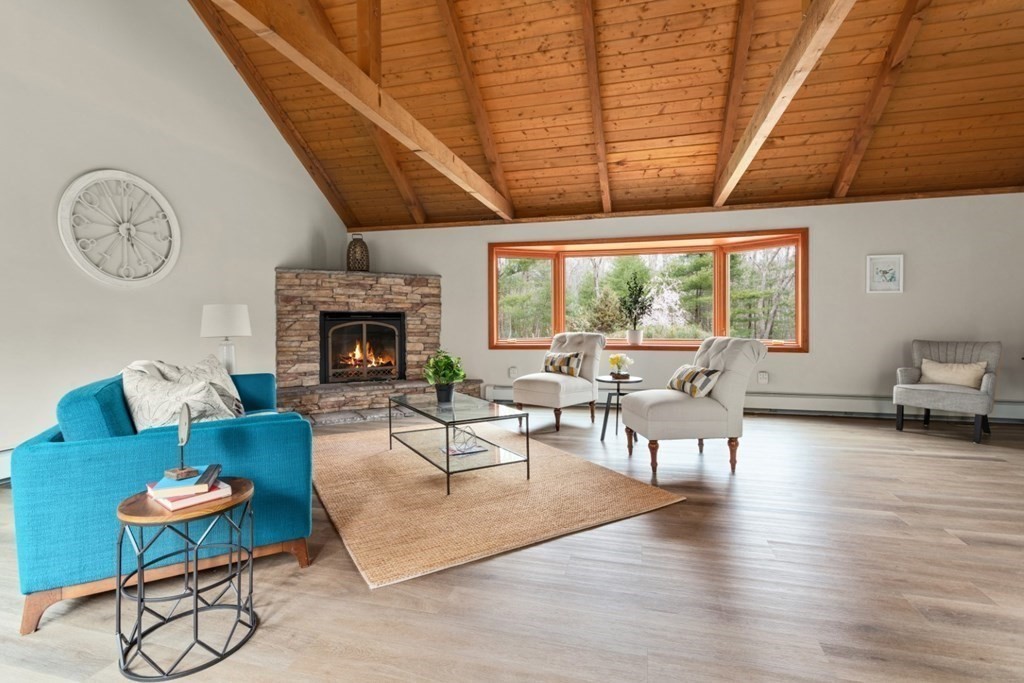 4 Darrell Drive North Reading, MA 01864 - Photo 12 of 41 a living room with furniture a fireplace a clock and a large window
