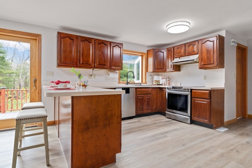 4 Darrell Drive North Reading, MA 01864 - Photo 14 of 41 a kitchen with stainless steel appliances granite countertop a stove a sink dishwasher and a refrigerator